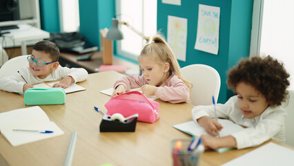 Group of kids students sitting on table studying at classroom