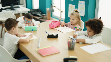 Group of kids students sitting on table studying at classroom