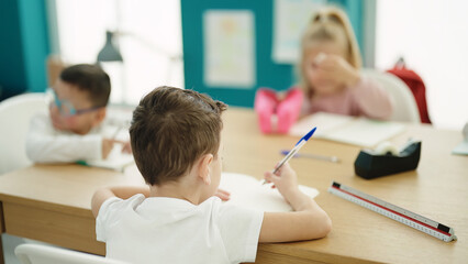 Group of kids students sitting on table studying at classroom