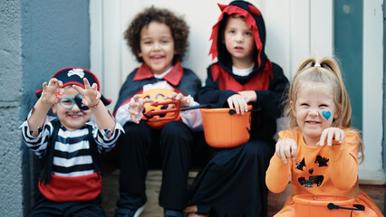 Obraz premium Group of kids wearing halloween costume doing fear gesture at street