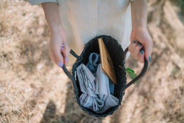 Top view of a girl showing the inside of her bag with clothes and a notebook