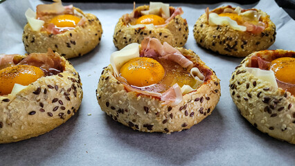 Multigrain rolls baked in the oven with ham, cheese and egg