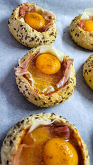 Multigrain rolls baked in the oven with ham, cheese and egg