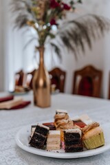 Closeup of a variety of cake pieces cut into cubes served on a plate