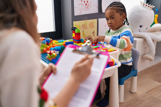 African American Boy Playing With Construction Blocks Having Psychotherapy At Kindergarten