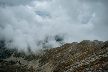 Beautiful view of a rocky mountain in fog