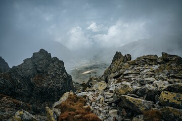Big rocks on the peak of a mountain under the cloudy gloomy sky