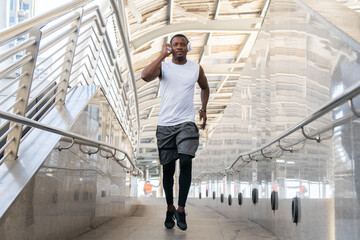 African american man in sportswear running outside in morning city. young male runner exercise jogging action sport, strong person athletic. health care concept.