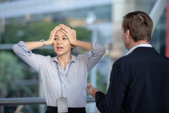 Stressed female scolding from boss. Man and woman talking controversy, Businesswoman and business man talking, arguing. Conflict problem manager and employee.