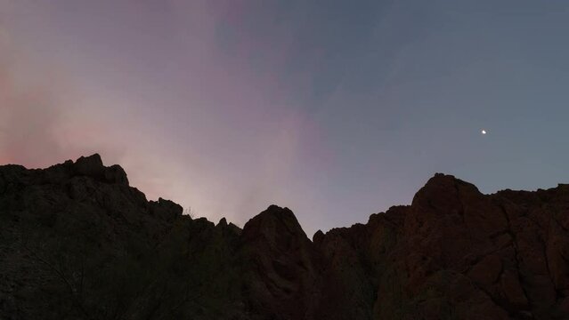Time lapse of sunrise sky over rugged canyon ridges in Painted Canyon in California, USA