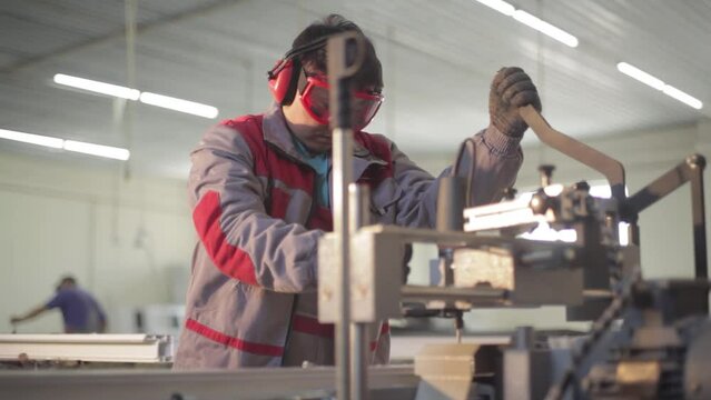 shop for the production of plastic windows. Workers make plastic windows, work machines and drills