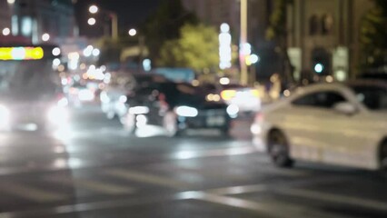 Traffic shot at night with lights and cityscape blurred background