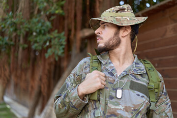 Fototapeta premium Young hispanic man wearing soldier uniform standing at park