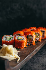 isolated sushi and rolls on a dark contrasting background, menu format

