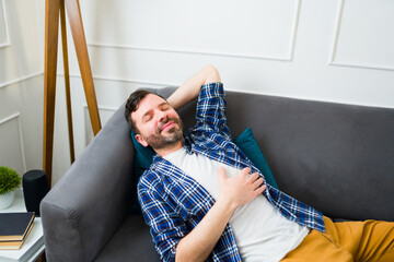 Caucasian man relaxing resting on the couch