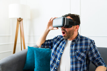 Surprised mid adult man excited about virtual reality technology