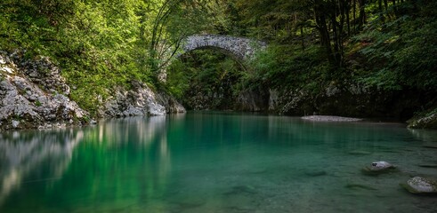 Natural view of the Napoleons Bridge over the Nadiza River in the forest of Slovenia
