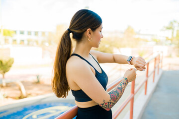 Athletic sporty woman using a fitness smartwatch