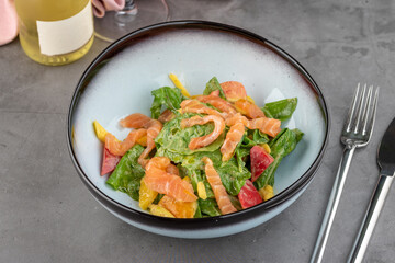 Salmon salad on stone table in fine dining restaurant