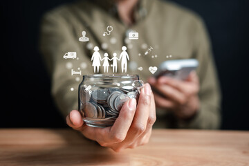 Businessman saving money coins accounting in jar for protect family and insurance concept. Protected from emergency by insurance and assurance health care life.