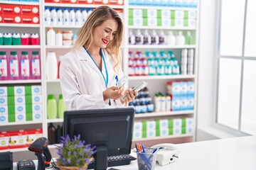 Young beautiful hispanic woman pharmacist smiling confident counting dollars at pharmacy