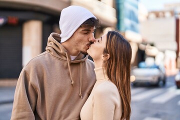 Fototapeta premium Mand and woman couple standing together kissing at street