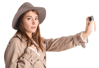 Young woman with pepper spray for self-defence on white background