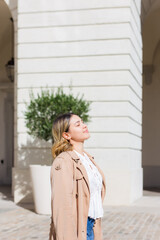 Woman breathing fresh air in a town street