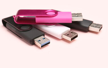 USB flash drives on pink background
