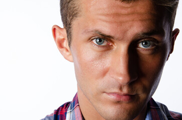 Young attractive man posing in the studio. White background.