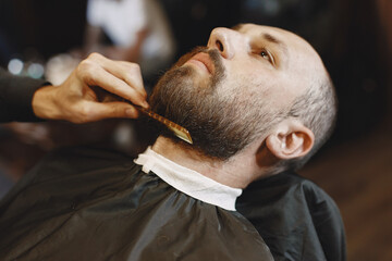 Naklejka premium Stylish man sitting in a barbershop