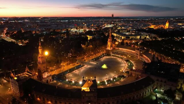 4k Aerial view of Plaza de Espana at sunrise in Seville, Spain. Night view of Maria Luisa Park