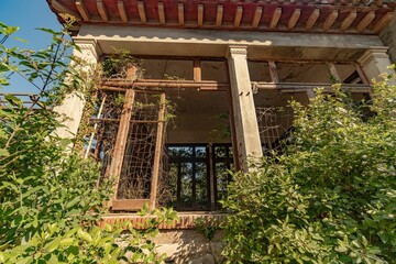 Low angle of an abandoned building covered with green plants in Montserrat,Barcelona,Catalonia,Spain