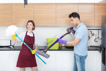 Young married couple cleaning kitchen. Household concept	