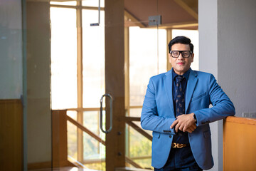 Indian corporate man giving expression at office.