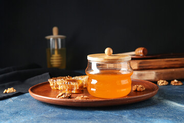 Jar of sweet honey and combs on table