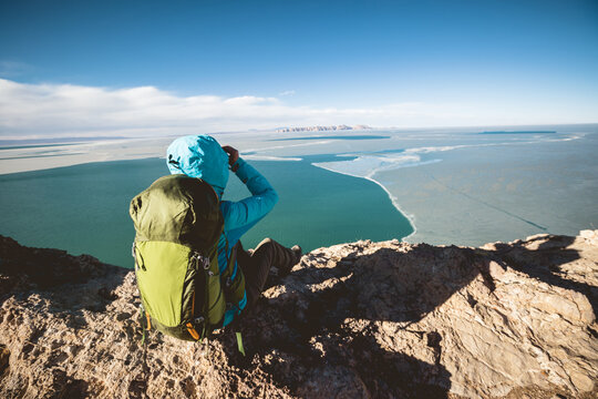 Woman hiker enjoy the ivew on mountain top cliff ege at lakeside