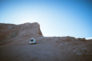 Driving off road car on the high altitude mountain slope