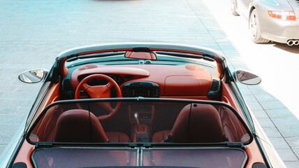 Red car interior with a roof down