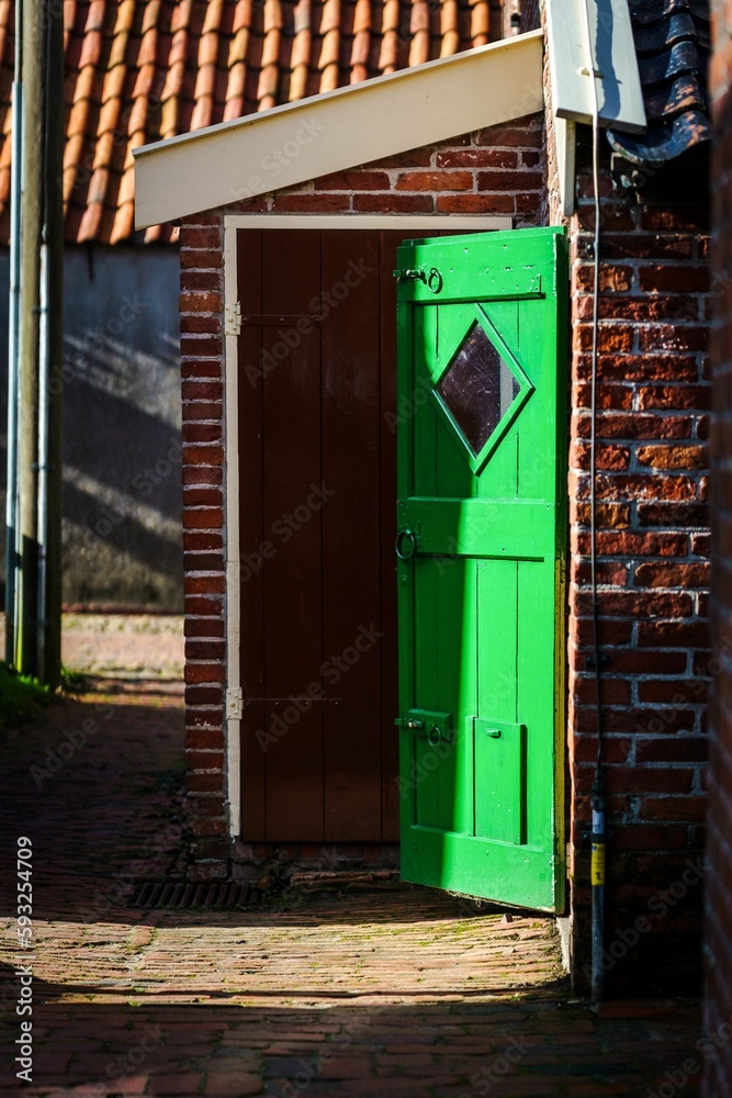 Sticker Green door at a small authentic village in the Netherlands