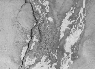 The structure of cracked wet earth at the bottom of the lake, creating irregular patterns, structure, background. Amazing shapes created by nature at the bottom of a lake where there is no water