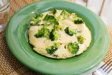 wholesome breakfast. omelet with broccoli on green plate
