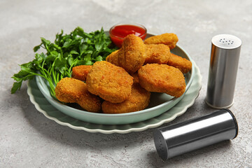 Plates with tasty nuggets on light background