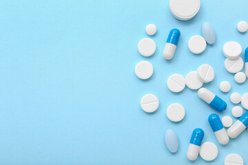 Different pills on blue background