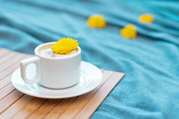 Cup of coffee with milk on a blue background with free space for text