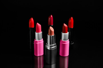 Set of beautiful lipsticks on dark background