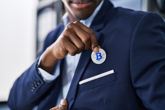 African american man business worker holding bitcoin at office