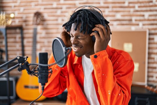 African american man musincian singing song at music studio