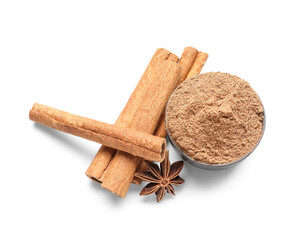 Bowl of powder with cinnamon sticks and anise on white background