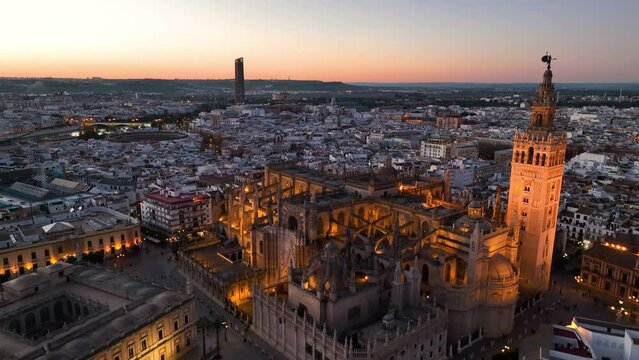 4k Aerial shot of Seville with gothic cathedral and famous Giralda bell tower. Seville, Spain.